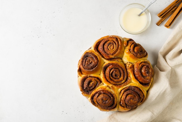 Cinnamon buns or rolls close up on white background