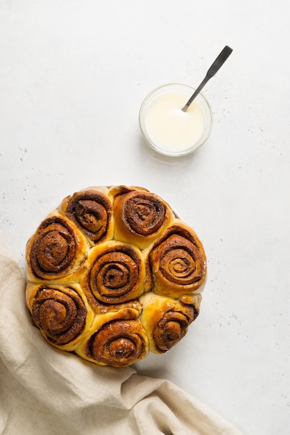 Cinnamon buns or rolls close up on white background
