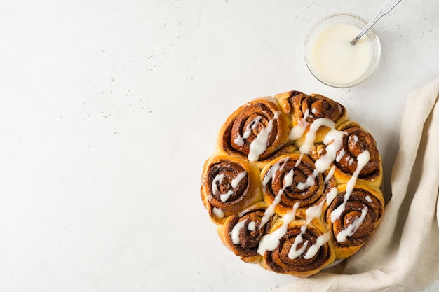 Cinnamon buns or rolls close up on white background