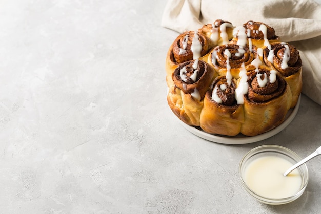 Cinnamon buns or rolls close up on white background