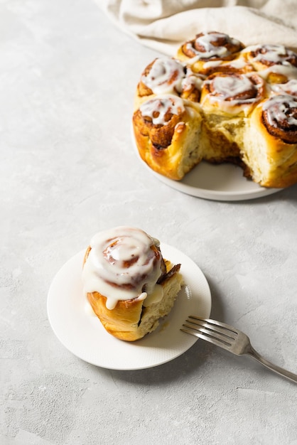 Cinnamon buns or rolls close up on white background