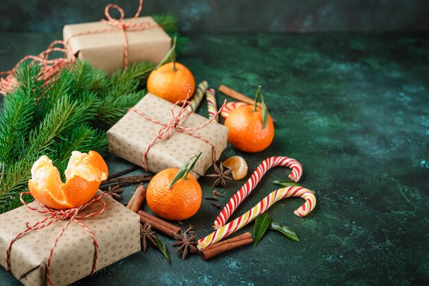 Cinnamon, candy canes and tangerines with leaves