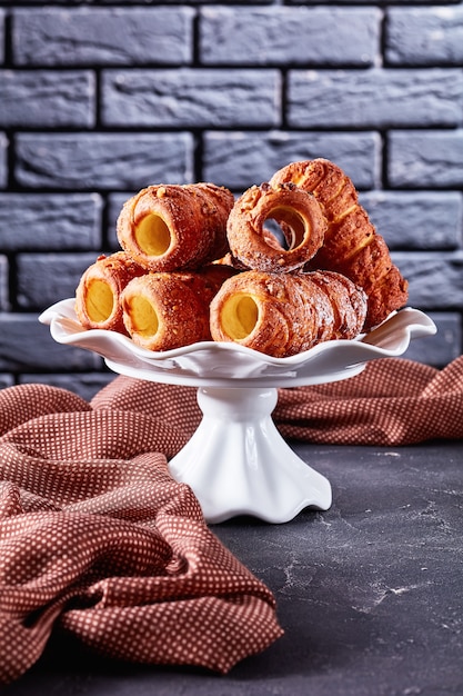 Cinnamon chimney cake on dark concrete background