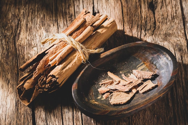 Cinnamon chips on rustic wood closeup view