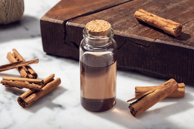 Cinnamon essential oil on marble table