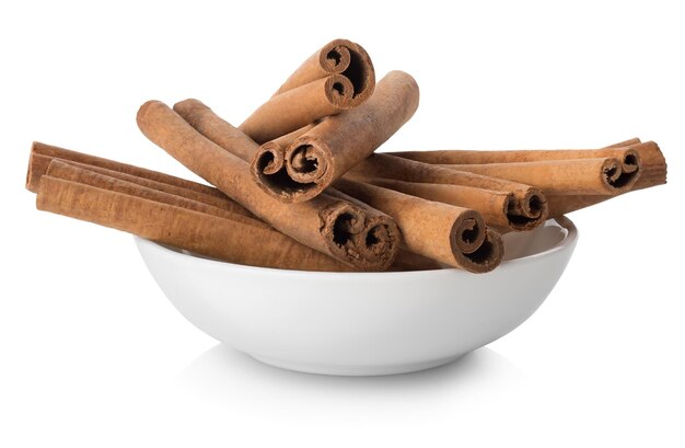 Cinnamon in plate isolated on white background