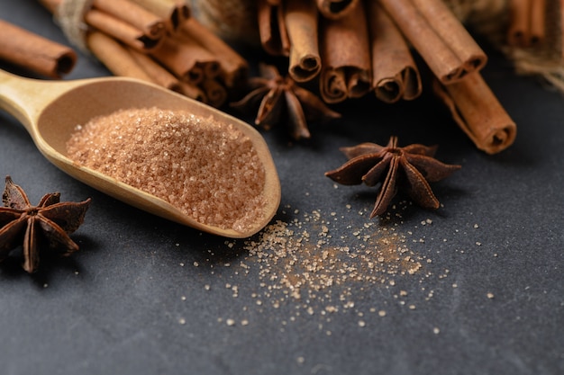 Cinnamon powder mix sugar on wood scoop 