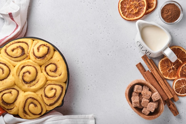 Cinnamon rolls or cinnabon homemade recipe raw dough preparation sweet traditional dessert buns pastry food baked homemade swirl Danish mini snack. Food ingridients. Top view. Fall baking concept