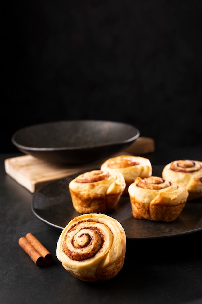 Cinnamon rolls on dark background