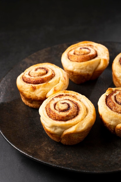 Cinnamon rolls on dark background