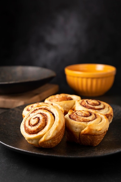 Cinnamon rolls on dark background