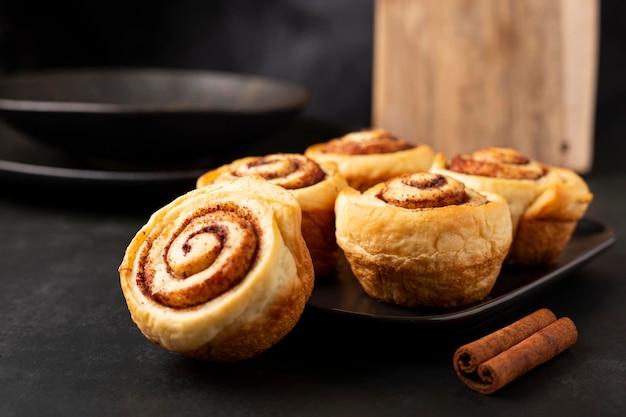 Cinnamon rolls on dark background