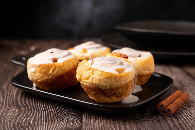 Cinnamon rolls on wooden background