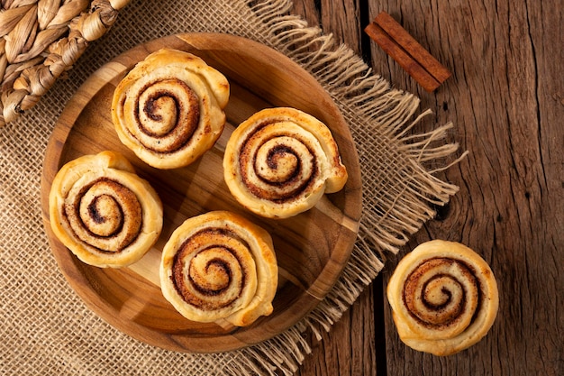 Cinnamon rolls on wooden background