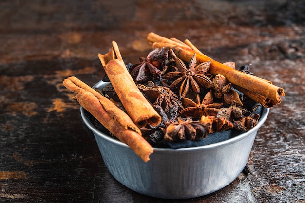 Cinnamon spices and anise stars in a bowl on the table