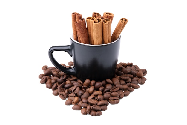 Cinnamon sticks in a black small cup with heart-shaped roasted coffee beans scattered around