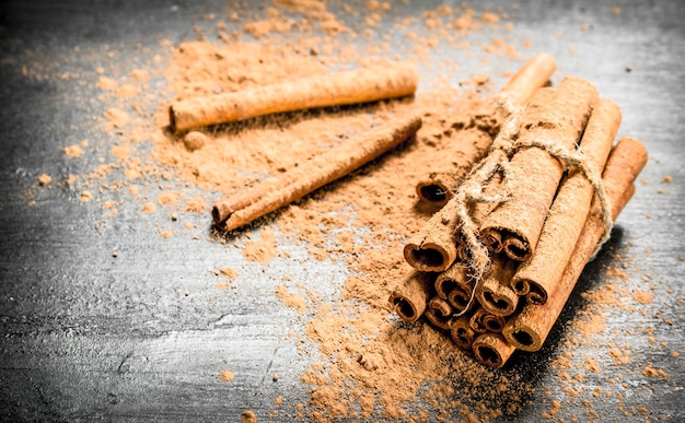 Cinnamon sticks. On a black wooden table.