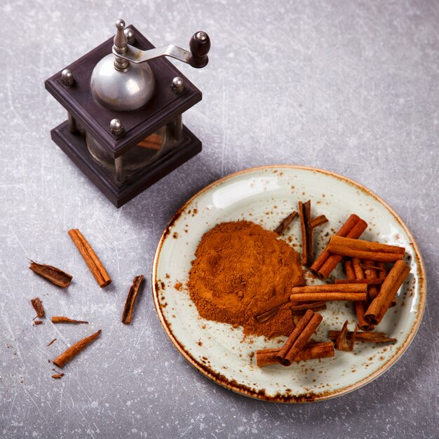 Cinnamon sticks and cinnamon powder on the plate