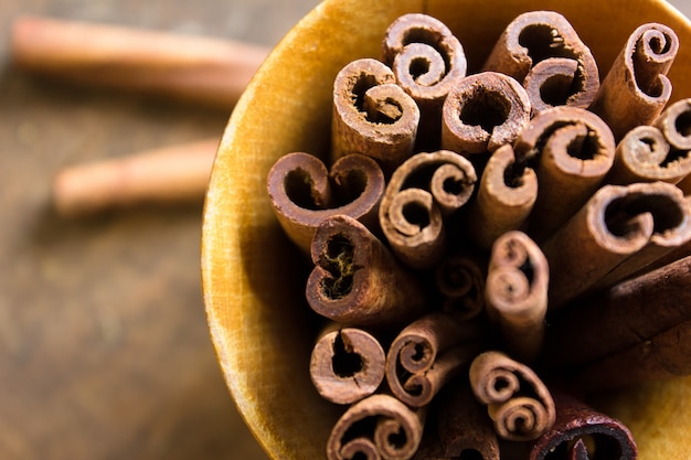 Cinnamon Sticks - A closeup of cinnamon sticks with ground cinnamon.