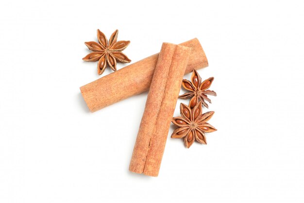 Cinnamon sticks and fragrant anise isolated on white wall