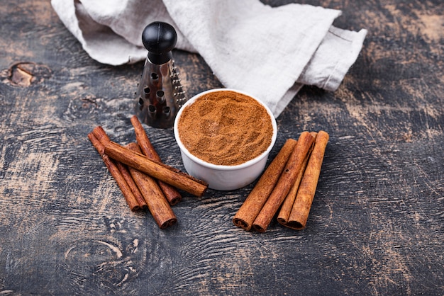 Cinnamon sticks and powder on black