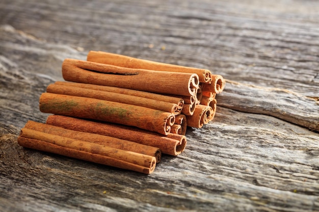 Cinnamon sticks stack set on old wooden surface