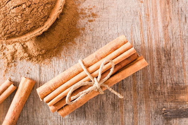 Cinnamon sticks tied with a rope on a wooden table