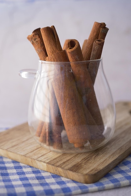 Cinnamon sticks in a transparent jar on table