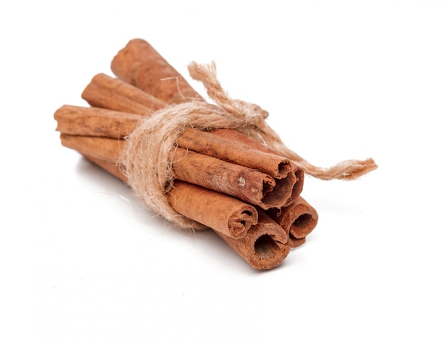 Cinnamon sticks on white surface