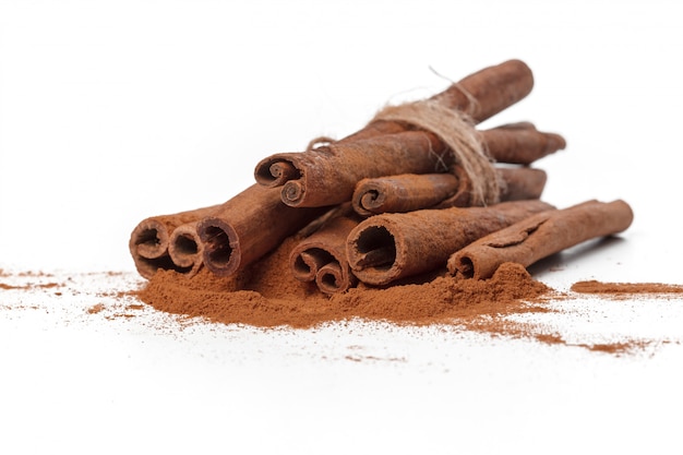 Cinnamon sticks on white surface