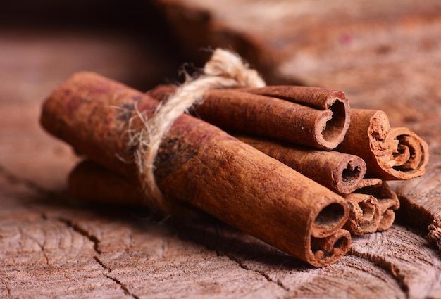 Cinnamon sticks on a wooden background