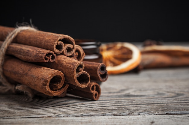 Cinnamon sticks on wooden surface 