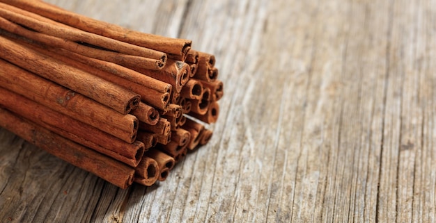 Cinnamon sticks on a wooden surface