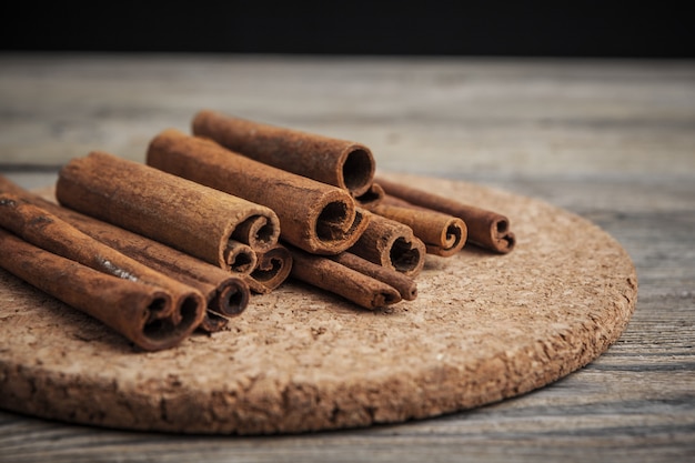 Cinnamon sticks on wooden table.