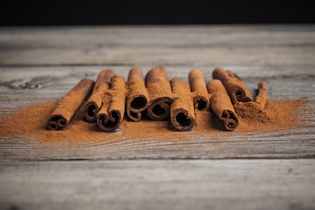 Cinnamon sticks on wooden table.