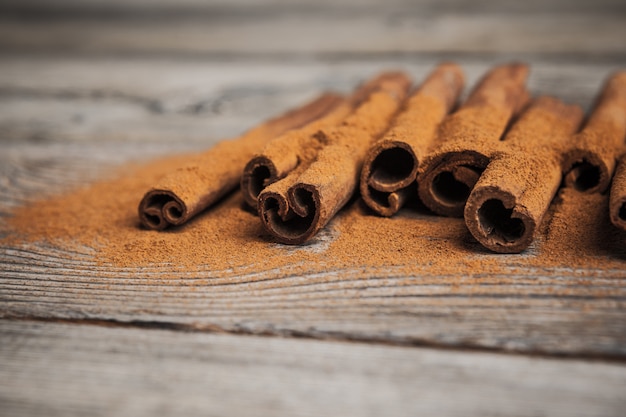 Cinnamon sticks on wooden table.