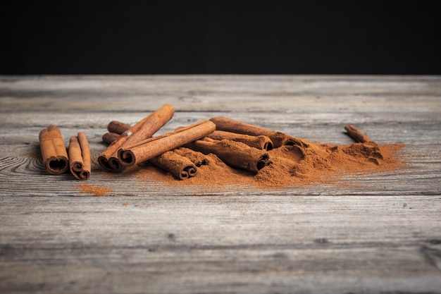 Cinnamon sticks on wooden table.