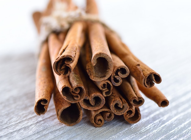 Cinnamon on white wood