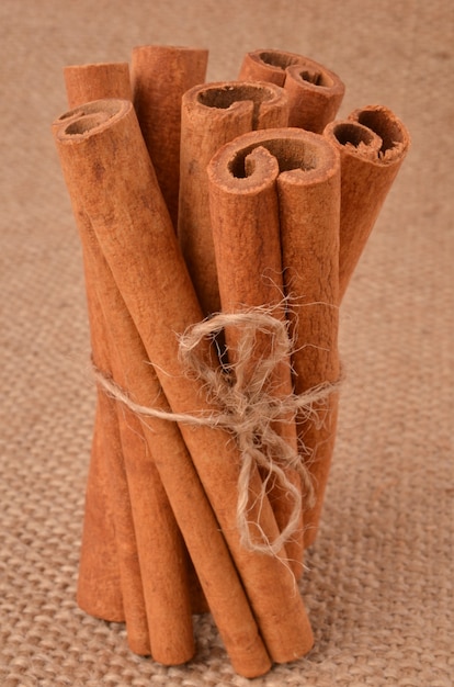 Cinnamon with coffee beans on a of burlap