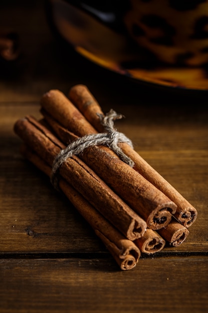 Cinnamon on the wooden background.