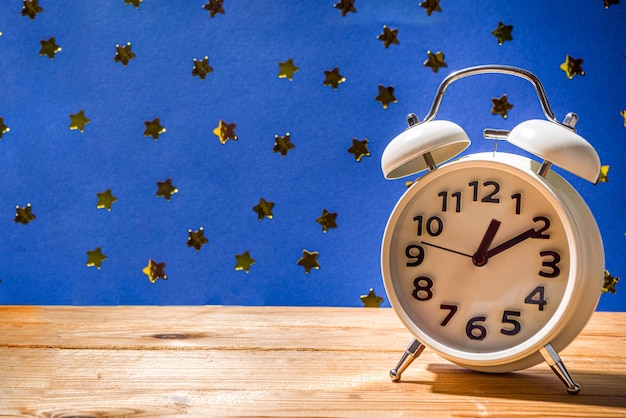 Circadian rhythms with white alarm clock, night and day backgrounds flatlay copy space