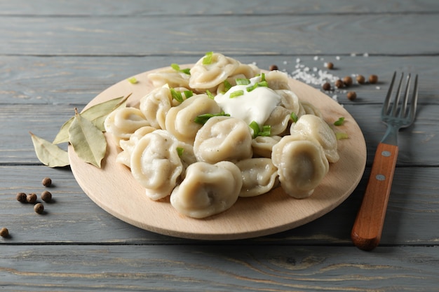 Circle board with dumplings on wooden