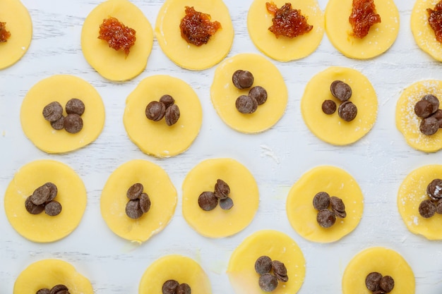 Circle dough cookies with chocolate chips prepared for baking