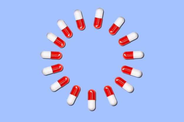 Circle of medical capsules on a blue background