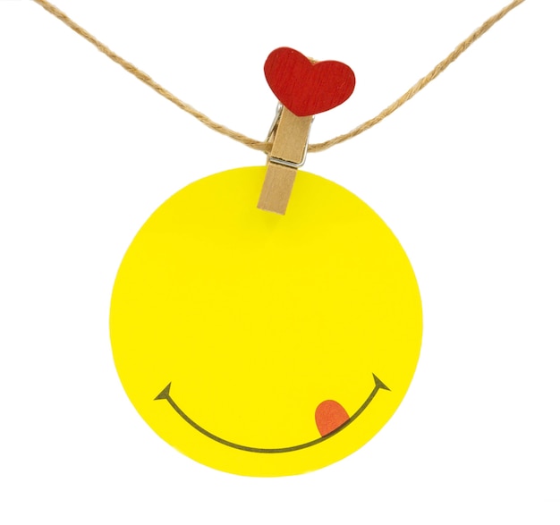 Circle yellow valentine note hanging on cord with clips with red heart head isolated on white