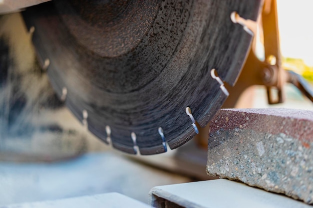 The circular diamond saw cuts concrete paving slabs. concrete\
cutting machine close-up.