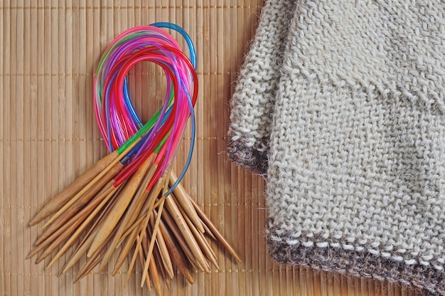 Circular knitting needles lie next to the beaches