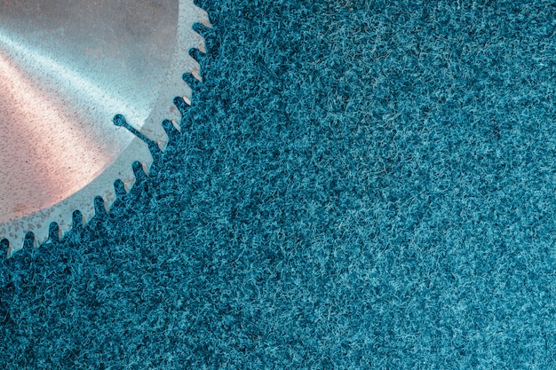 Circular saw blade lies on dark , top view.