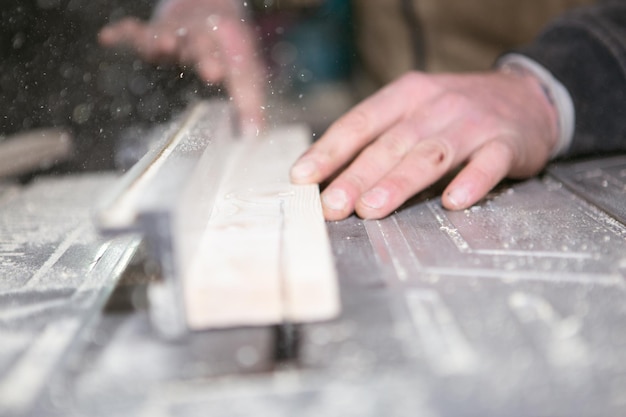 Circular saw A carpenter uses a circular saw to process wood Closeup photo