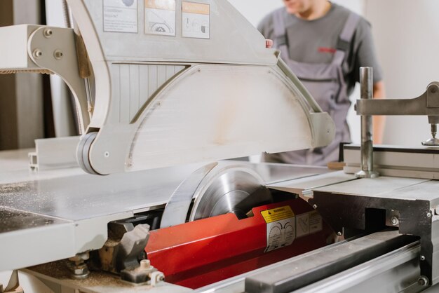 Circular saw for cutting wood materials on a woodworking machine at a furniture factory